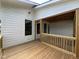 New wood deck showing white siding, black trimmed windows and entrance to screened porch at 269 Deer Tail Ln # 44, Fuquay Varina, NC 27526
