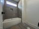 Modern bathroom showcasing a soaking tub with dark gray tile surround, offering a luxurious bathing experience at 269 Deer Tail Ln # 44, Fuquay Varina, NC 27526