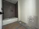 Modern bathroom with a tiled shower and tub combo featuring gray accent tiles and matte black fixtures at 269 Deer Tail Ln # 44, Fuquay Varina, NC 27526