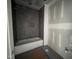 Unfinished bathroom features a modern tub and tiled wall at 269 Deer Tail Ln # 44, Fuquay Varina, NC 27526