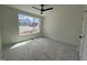 Bright bedroom featuring a modern ceiling fan and large window, showcasing natural light at 269 Deer Tail Ln # 44, Fuquay Varina, NC 27526
