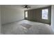 Unfinished bedroom features paneling, natural light from two windows, and modern ceiling fan at 269 Deer Tail Ln # 44, Fuquay Varina, NC 27526