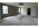 Unfinished Primary bedroom with paneling, ceiling fan, natural light from two windows and ensuite access at 269 Deer Tail Ln # 44, Fuquay Varina, NC 27526