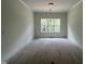 Bright dining room featuring a modern light fixture, recessed lights, and a large window at 269 Deer Tail Ln # 44, Fuquay Varina, NC 27526