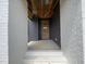 Modern entryway features a light-colored front door, gray accents, and white brick walls for a sleek welcome at 269 Deer Tail Ln # 44, Fuquay Varina, NC 27526