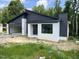 Contemporary home boasts dark siding, white brick, a metal roof, and an attached two-car garage at 269 Deer Tail Ln # 44, Fuquay Varina, NC 27526
