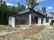 Beautiful modern home featuring dark gray siding, white brick accents, and an open two car garage at 269 Deer Tail Ln # 44, Fuquay Varina, NC 27526