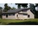 An exterior view showcasing the home's modern design, deck, and backyard trees and landscaping at 269 Deer Tail Ln # 44, Fuquay Varina, NC 27526