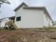 Side view of a modern white home with a wooden deck and stairs, offering a glimpse of contemporary design at 269 Deer Tail Ln # 44, Fuquay Varina, NC 27526