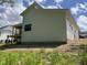 A newly built home features a neutral exterior with dark trim windows and a backyard deck at 269 Deer Tail Ln # 44, Fuquay Varina, NC 27526