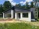 Eye-catching modern home with dark gray siding, white brick details, and inviting curb appeal at 269 Deer Tail Ln # 44, Fuquay Varina, NC 27526