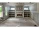 Living room with fireplace, built-in shelves and many windows being remodeled at 269 Deer Tail Ln # 44, Fuquay Varina, NC 27526