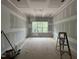 Room being remodeled with drywall hung on the walls and ceiling, featuring a large window at 269 Deer Tail Ln # 44, Fuquay Varina, NC 27526