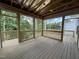 Newly built screened porch with wood flooring overlooking serene wooded backyard at 269 Deer Tail Ln # 44, Fuquay Varina, NC 27526