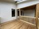 Partially completed screened porch featuring wooden railing, wood flooring, and black framed windows at 269 Deer Tail Ln # 44, Fuquay Varina, NC 27526