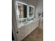 Bathroom vanity with dual sinks, white cabinetry, and lighted mirrors create a clean, modern aesthetic at 2833 Praire View Pt, Wendell, NC 27591