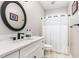 Updated bathroom with sleek vanity, modern fixtures, round mirror, and shower with tub at 2833 Praire View Pt, Wendell, NC 27591