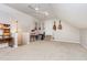 Large bonus room with guitars, carpeting, desk, chandelier, and a fan at 2833 Praire View Pt, Wendell, NC 27591