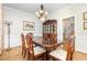 Elegant dining room featuring traditional furniture, wainscoting, and a decorative chandelier at 2833 Praire View Pt, Wendell, NC 27591