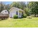 Detached garage on grassy lot with mature trees, a trailer and picnic table at 2833 Praire View Pt, Wendell, NC 27591