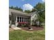 Charming home exterior featuring a sunroom addition, beautiful landscaping, and manicured lawn, enhancing curb appeal at 2833 Praire View Pt, Wendell, NC 27591