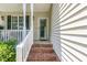 Close-up of the brick-step front porch with white siding and green foliage accents at 2833 Praire View Pt, Wendell, NC 27591