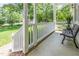 Inviting front porch featuring white railings, decorative pillars, and a cozy bench for relaxing at 2833 Praire View Pt, Wendell, NC 27591