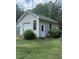 Detached garage exterior featuring a garage door, side door, and simple landscaping, offering functionality and charm at 2833 Praire View Pt, Wendell, NC 27591