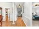 Bright hallway with hardwood floors, white wainscoting, and views into other living spaces at 2833 Praire View Pt, Wendell, NC 27591