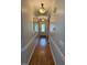 Inviting hallway with hardwood floors and decorative lighting at 2833 Praire View Pt, Wendell, NC 27591