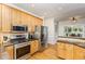 Well-equipped kitchen with stainless steel appliances, wood cabinets, and a breakfast bar at 2833 Praire View Pt, Wendell, NC 27591