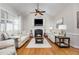 Cozy living room featuring vaulted ceilings, a fireplace, hardwood floors and lots of natural light at 2833 Praire View Pt, Wendell, NC 27591