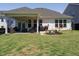 Spacious backyard with a covered porch, landscaping, and well-maintained lawn at 2909 Thurman Dairy Loop, Wake Forest, NC 27587