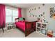 Cozy bedroom with natural light, wood bed frame, and personal decorations at 2909 Thurman Dairy Loop, Wake Forest, NC 27587