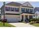 Inviting two-story home with a covered front porch, showcasing curb appeal at 2909 Thurman Dairy Loop, Wake Forest, NC 27587