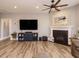 Comfortable living room featuring a fireplace, large TV, and hardwood floors at 2909 Thurman Dairy Loop, Wake Forest, NC 27587