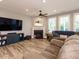 Inviting living room with fireplace, large TV, hardwood floors, and comfortable seating at 2909 Thurman Dairy Loop, Wake Forest, NC 27587