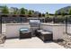 Outdoor kitchen with built-in grill and seating, perfect for entertaining near the pool at 2909 Thurman Dairy Loop, Wake Forest, NC 27587