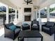 Comfortable outdoor living area featuring a fireplace, tv, ceiling fan, and stylish seating arrangements at 2909 Thurman Dairy Loop, Wake Forest, NC 27587