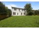 Back exterior of a two-story home featuring a well-maintained lawn and multiple windows for natural light at 333 Trout Valley Rd, Wake Forest, NC 27587