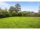 Spacious backyard surrounded by lush greenery offering privacy and a serene outdoor space at 333 Trout Valley Rd, Wake Forest, NC 27587