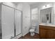Bathroom featuring a glass door shower and a vanity with a window providing natural light at 333 Trout Valley Rd, Wake Forest, NC 27587