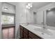 Bathroom featuring dual sinks, a large mirror, and a neutral color palette at 333 Trout Valley Rd, Wake Forest, NC 27587