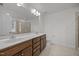 A bathroom with double sinks, a large mirror, and tile flooring and countertops at 333 Trout Valley Rd, Wake Forest, NC 27587