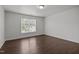 Bright bedroom featuring hardwood floors, a large window, and neutral paint at 333 Trout Valley Rd, Wake Forest, NC 27587