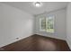 A simple bedroom with hardwood floors and lots of natural light streaming in from the window at 333 Trout Valley Rd, Wake Forest, NC 27587
