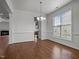 Bright dining room featuring hardwood floors, crown molding, and ample natural light from a large window at 333 Trout Valley Rd, Wake Forest, NC 27587