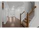 Foyer with hardwood floors, a staircase with carpeted steps, and a view of the front door at 333 Trout Valley Rd, Wake Forest, NC 27587
