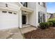 Inviting front entrance featuring a black door, complemented by a tidy lawn and a two-car garage at 333 Trout Valley Rd, Wake Forest, NC 27587