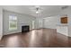 Open living room with hardwood floors, a fireplace, and lots of natural light from the windows and glass door at 333 Trout Valley Rd, Wake Forest, NC 27587